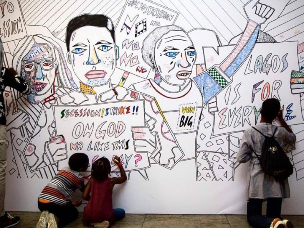 Karo Akpokiere's life size colouring wall installation saw guests add in their own colour, patterns, and signatures in this interactive piece that aimed to highlight the glaring divide between the social classes in Lagos.