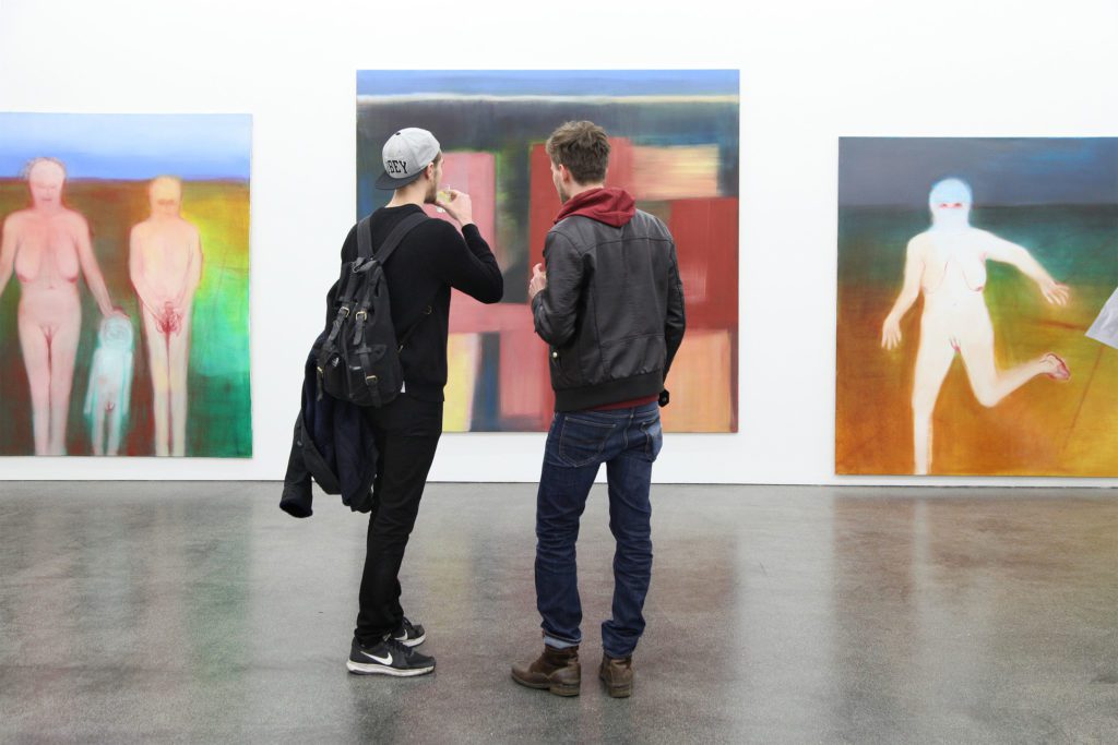 Visitors looking at works by Miriam Cahn at Meyer Riegger Gallery at Berlin Gallery Weekend 2016. Photo courtesy Berlin Gallery Weekend.