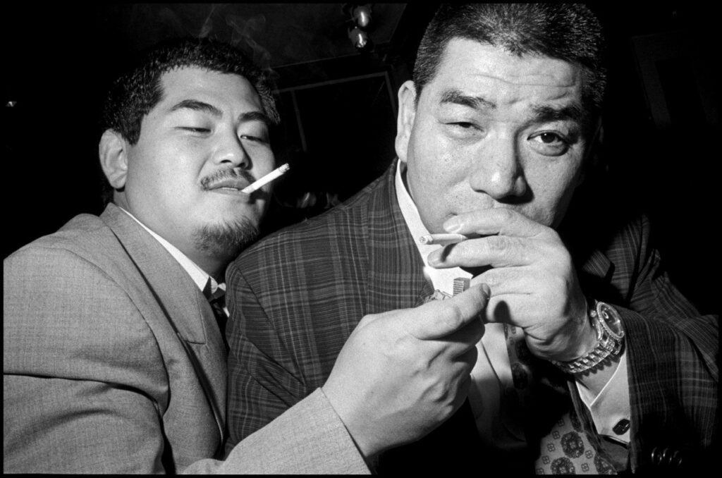 Bruce Gilden JAPAN. Asakusa. 1998. Two members of the Yakuza, Japan's mafia. The Yakuza's 23 gangs are Japan's top corporate earners. They model themselves on American gangster fashion from the 1950s. © Bruce Gilden | Magnum Photos