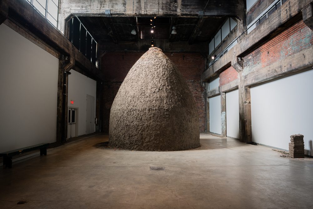 Dineo Seshee Bopape, and-in. the light of this.______, 2017. Installation, soil, straw, clay, feather, stone, fabric, flower, wax, fur, metal, shell. © Maxime Boisvert.