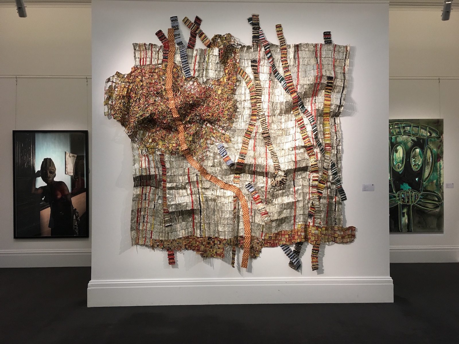 Works by Leonce Raphael Agbodjelou, El Anatsui, and Abdoulaye Diarrassouba (Aboudia) at the Sotheby’s Modern and Contemporary African Art Sale Exhibition, London, May 2017 © Patricia A. Banks