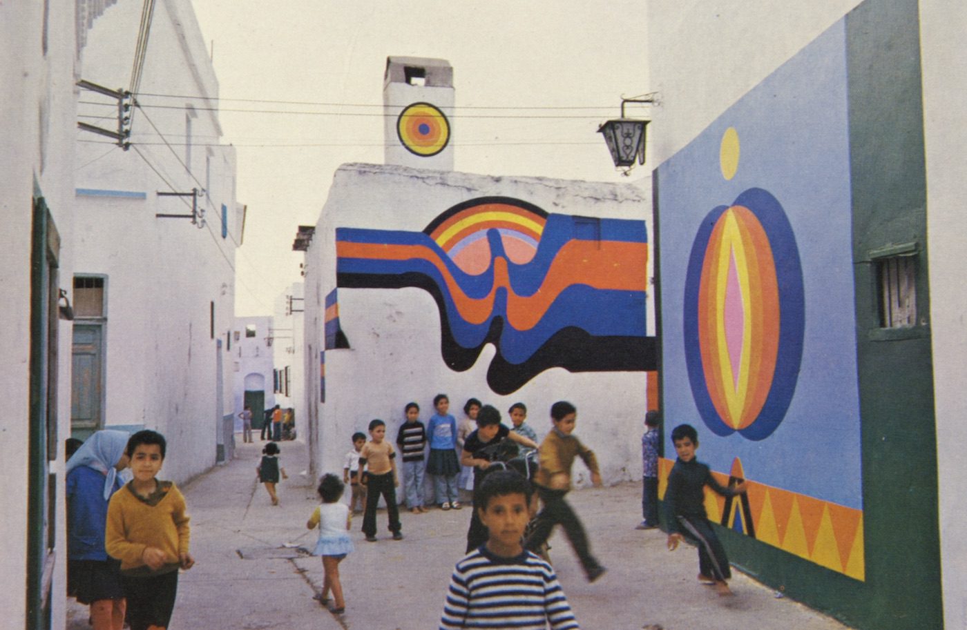 Mural paintings by Farid Belkahia (center) and Mohammed Hamidi (right), Asilah, Morocco. Both 1978. As published in Asilah: Premier moussem culturel, juillet/août 1978, exh. cat. (Casablanca: Shoof, 1978). Reproduced by permission of the photographer, Mohammed Melehi.