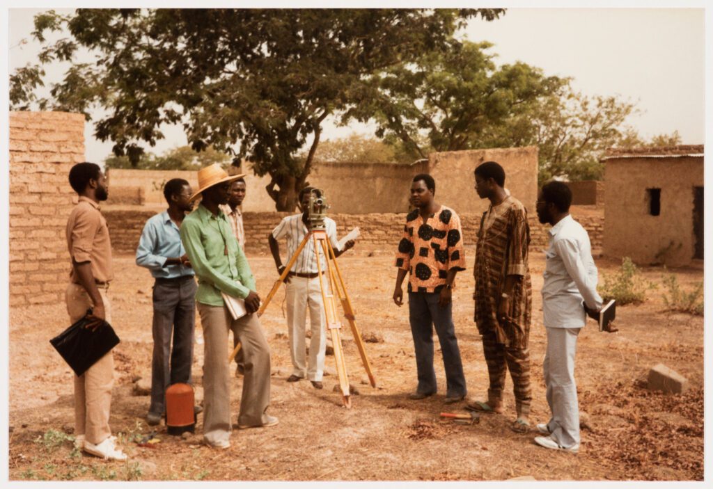 The Brigade Topographique Burkinabé marks the plots for a new urban plan for the Nossin, Wagadogo, and Tampouy districts of Ougadougou, Burkina Faso, 1985. Coen Beeker, photographer and Collection, CCA. ARCH281675. Gift of African Architecture Matters