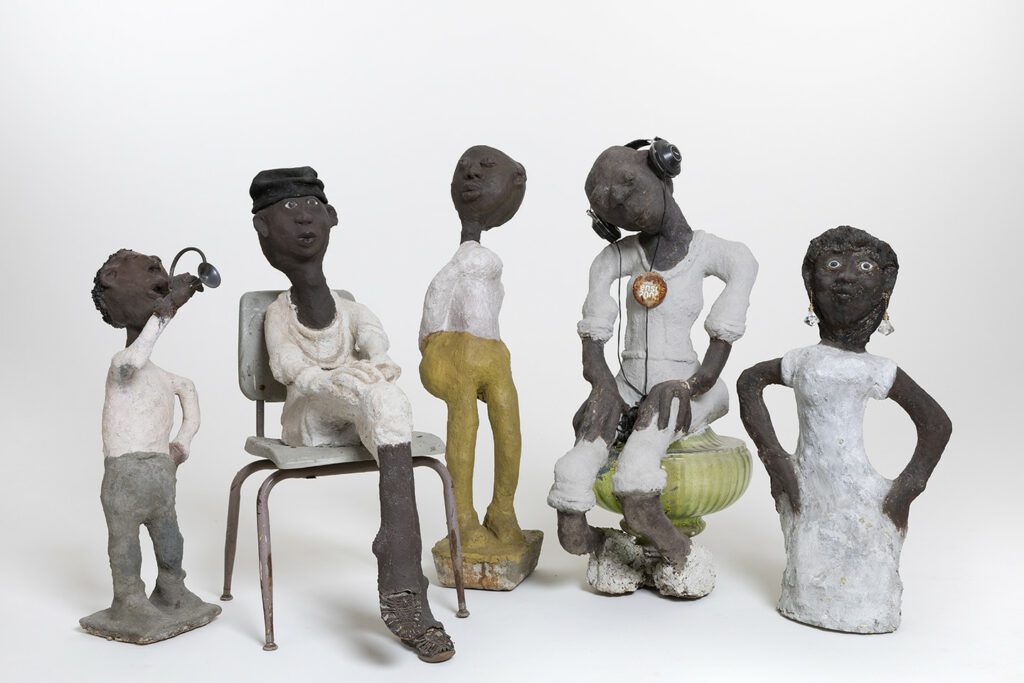 Dr. Charles Smith, (from left) Horn Player: Louis Armstrong Series, c. 1985–c. 1999; concrete, paint, and mixed media; 32 3/4 x 9 1/2 x 13 1/2 in. Rosa Parks, c. 1985–c. 1999; concrete, paint, and mixed media; 40 x 18 3/4 x 29 in. Untitled, c. 1985–c. 1999; concrete, paint, and mixed media; 44 1/2 x 9 1/2 x 12 in. Issues, c. 1985–c. 1999; concrete, paint, and mixed media; 46 x 18 x 25 in. Woman with Fancy Earrings, c. 1985–c. 1999; concrete, paint, and mixed media; 36 x 18 x 10 in. John Michael Kohler Arts Center Collection, gift of Kohler Foundation Inc. Photo courtesy of John Michael Kohler Arts Center.
