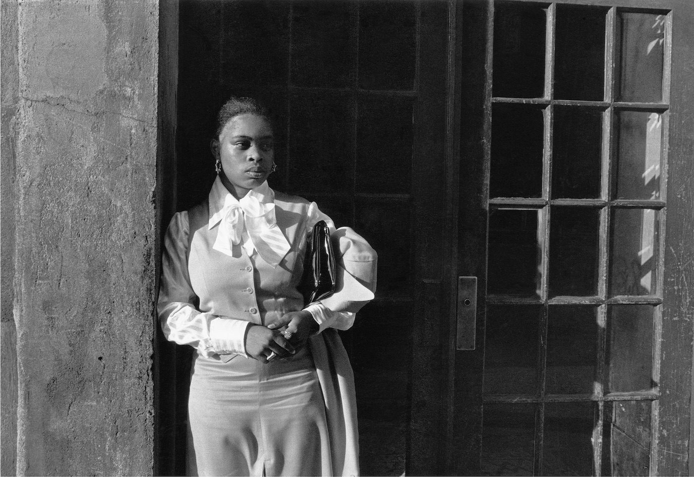 A Woman Waiting in the Doorway, Harlem, NY, 1976. Photograph by Dawoud Bey
