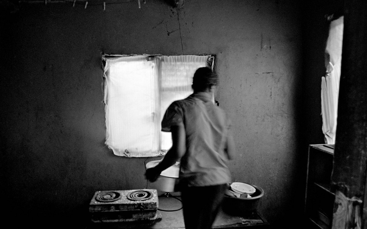Santu Mofokeng, Rister Mkansi in the family kitchen Dan location, Tzaneen, Limpopo, South Africa Black and white, 35mm film, 2007.