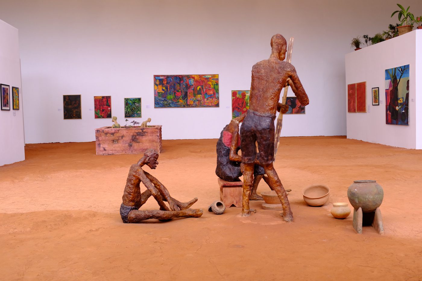 An assemblage depicting a couple pounding fufu while a child sits to the side. Photo: Kelvin Haizel
