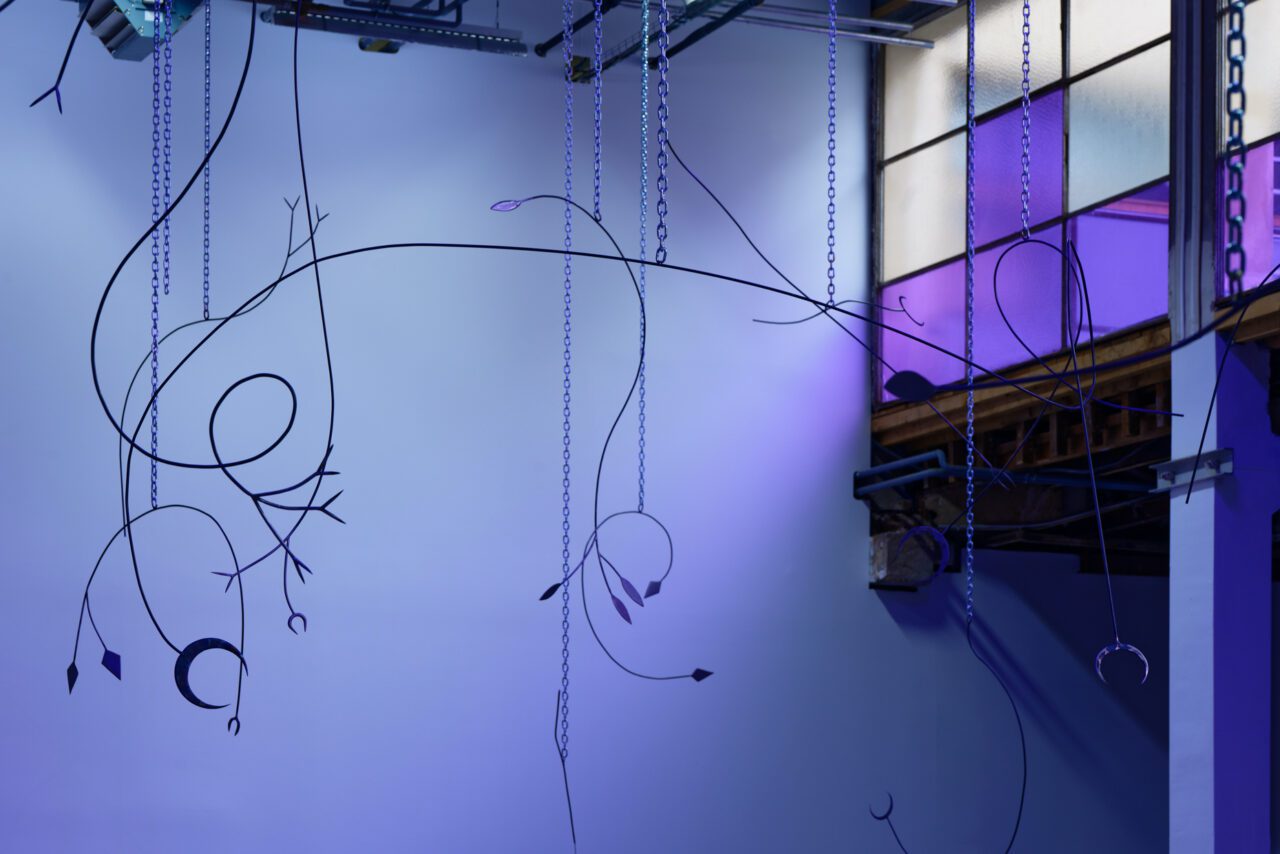 Tarek Lakhrissi, Unfinished Sentence II, 2020. Installation of 30 metal spears and performance with chains, colour filter, loud speakers. Palais de Tokyo, Paris, FR. Photography: Aurélien Mole.

